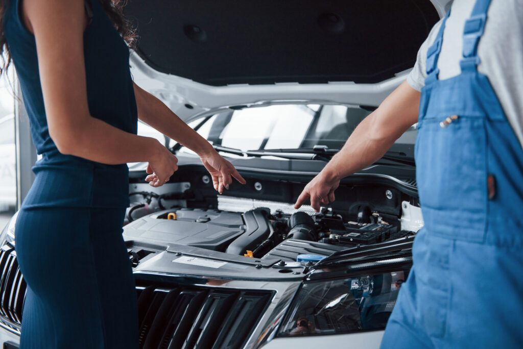 I Guess Your Problem That Part Woman Auto Salon With Employee Blue Uniform Taking Her Repaired Car Back 1