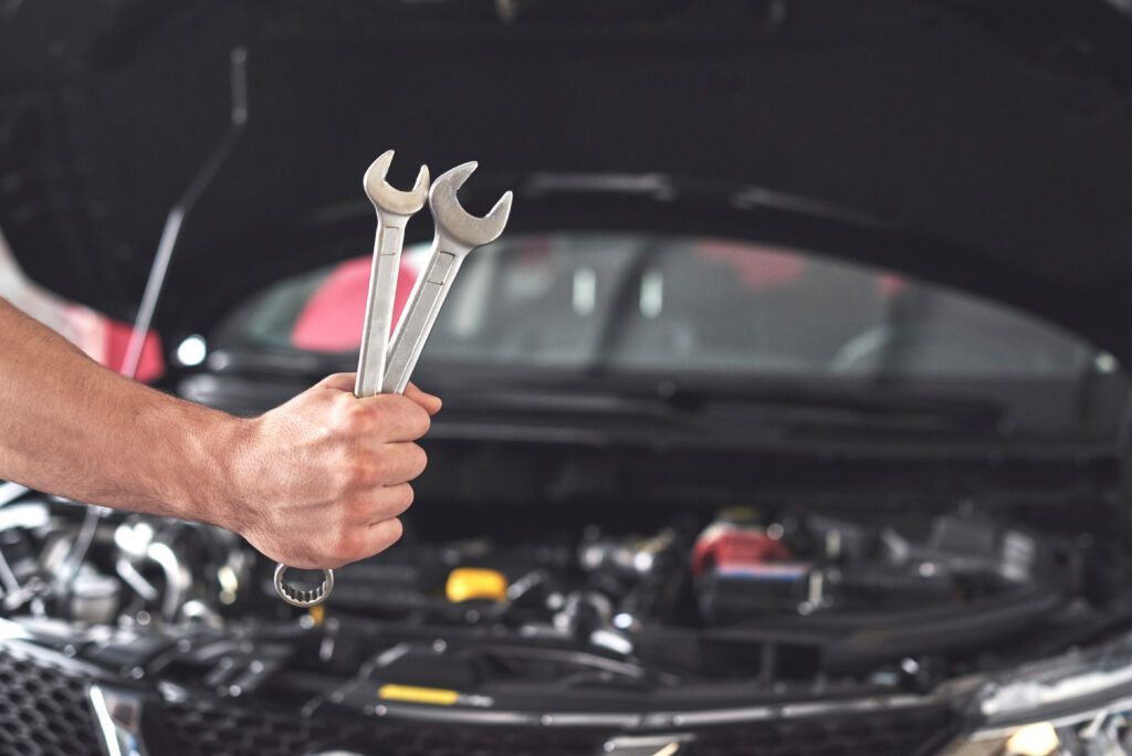 Mechanic Holding Pair Wrenches Repair Garage
