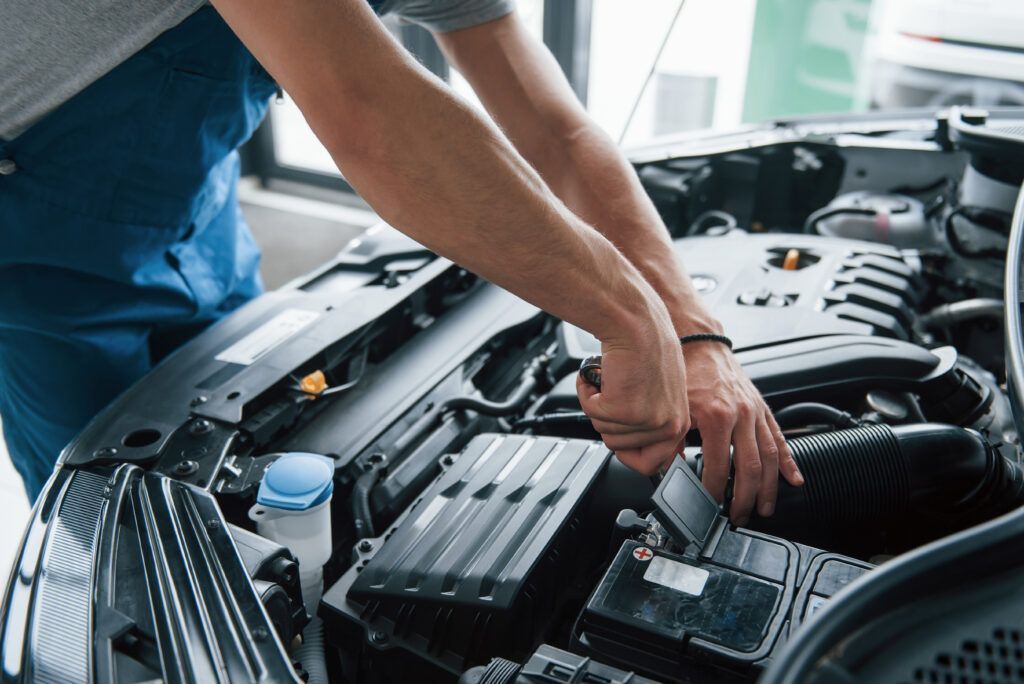 Some Electronic Parts Process Repairing Car After Accident Man Working With Engine Hood 1