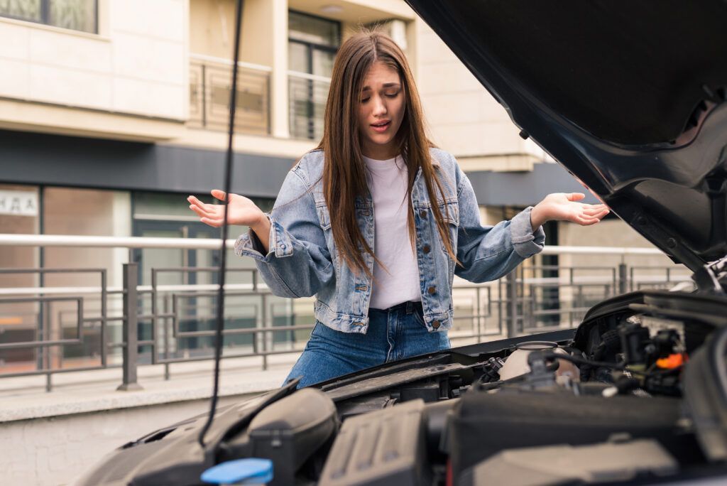 Young Worried Girl Is Using Phone Explain Mechanic Problem With Car That She Has